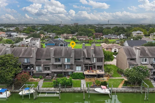 an aerial view of a houses with a lake