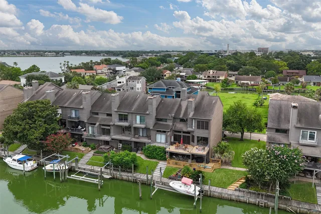 an aerial view of a city with lots of residential buildings and mountain view in back