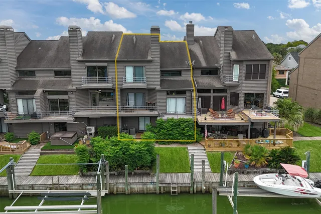 a aerial view of a brick house with a yard and plants