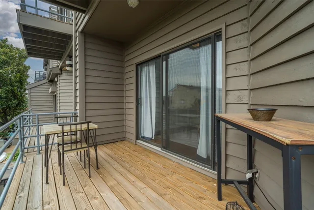 a balcony with table and chairs