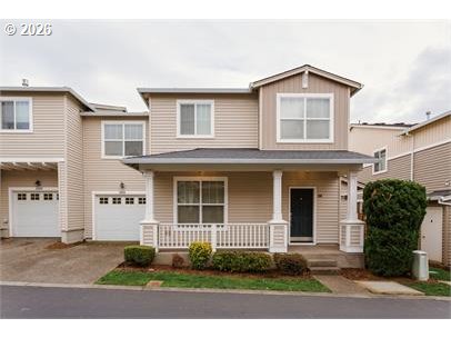 12820 Southwest Dipper Lane, Unit 100 Beaverton, OR 97007 - Photo 1 of 18 a front view of a house with a yard