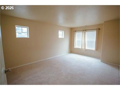 12820 Southwest Dipper Lane, Unit 100 Beaverton, OR 97007 - Photo 12 of 18 a view of an empty room with a window
