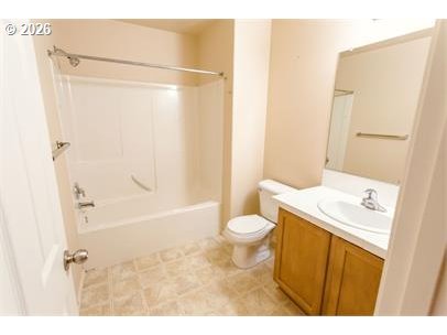 12820 Southwest Dipper Lane, Unit 100 Beaverton, OR 97007 - Photo 15 of 18 a bathroom with a sink a toilet and shower