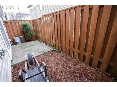 a view of a backyard with wooden fence