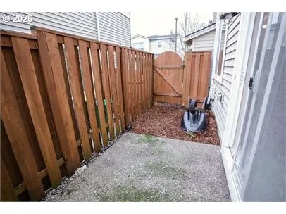 a view of a backyard with wooden fence