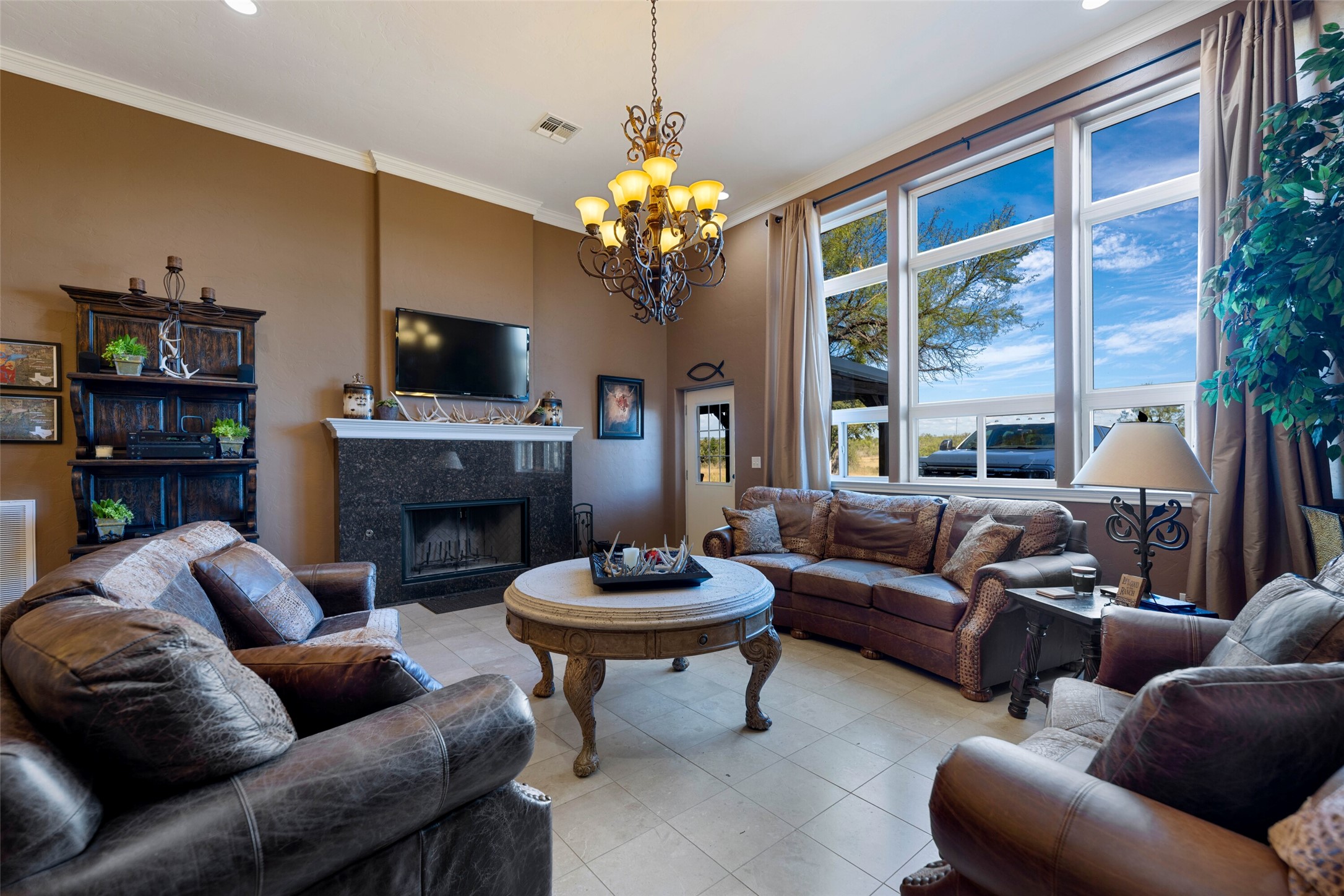 7702 Ranch Road 965 Llano, TX 78643 - Photo 9 of 40 a living room with furniture a fireplace and a flat screen tv