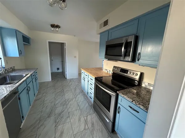 a kitchen with a stove and a microwave