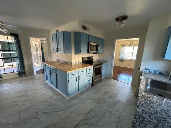 a kitchen with stainless steel appliances granite countertop a stove and a sink