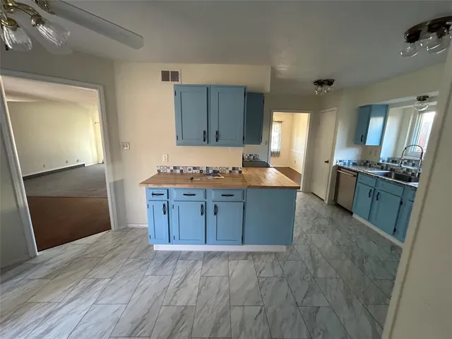 an empty room with fireplace and windows