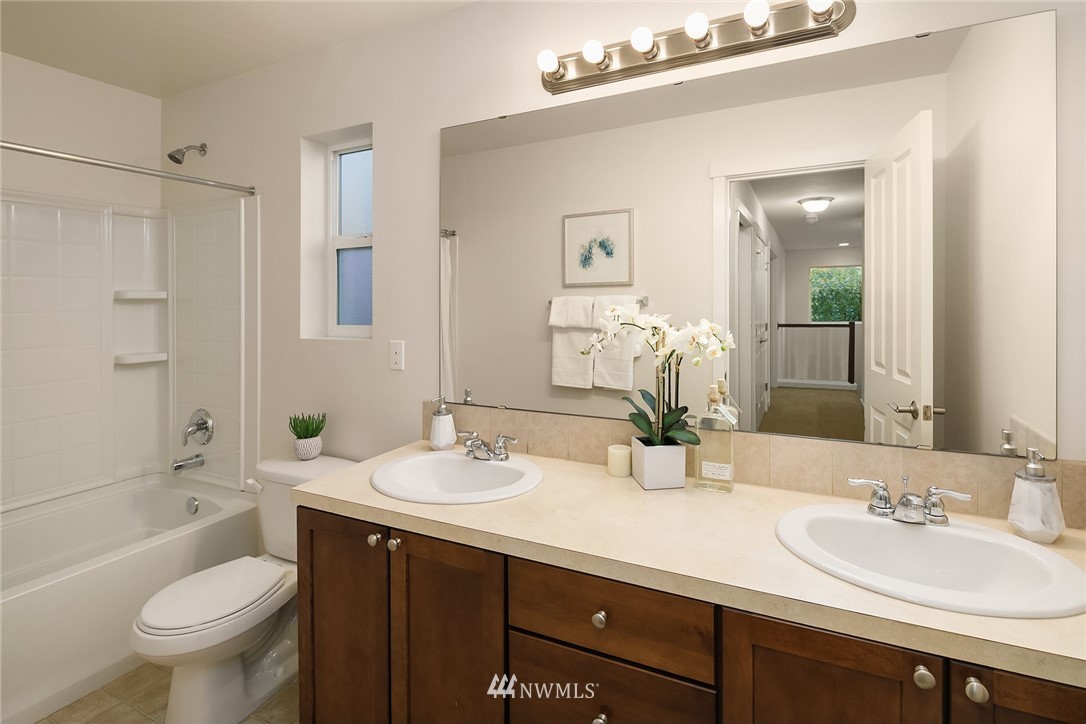 3728 224th Street Southeast Bothell, WA 98021 - Photo 12 of 22 a bathroom with a double vanity sink toilet mirror and bathtub