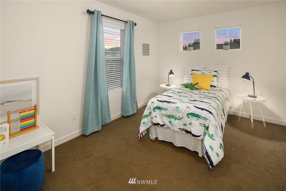 3728 224th Street Southeast Bothell, WA 98021 - Photo 13 of 22 a bedroom that has a bed and a table in it