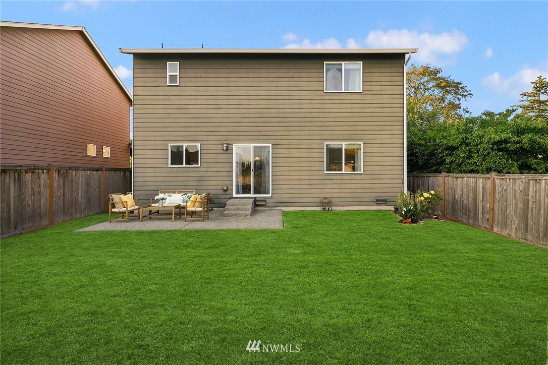 3728 224th Street Southeast Bothell, WA 98021 - Photo 17 of 22 a backyard of a house with table and chairs