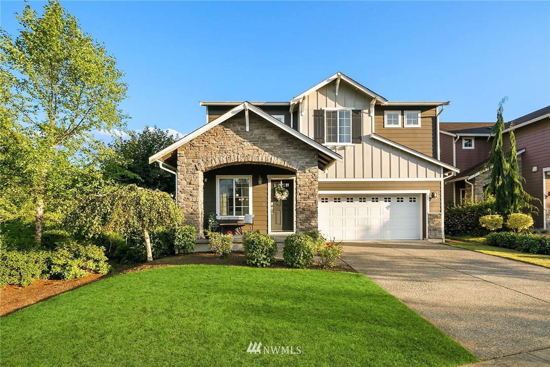 3728 224th Street Southeast Bothell, WA 98021 - Photo 21 of 22 a front view of a house with a yard and garage