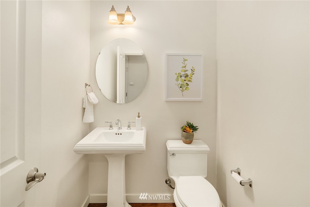 3728 224th Street Southeast Bothell, WA 98021 - Photo 6 of 22 a bathroom with a sink a mirror and a toilet