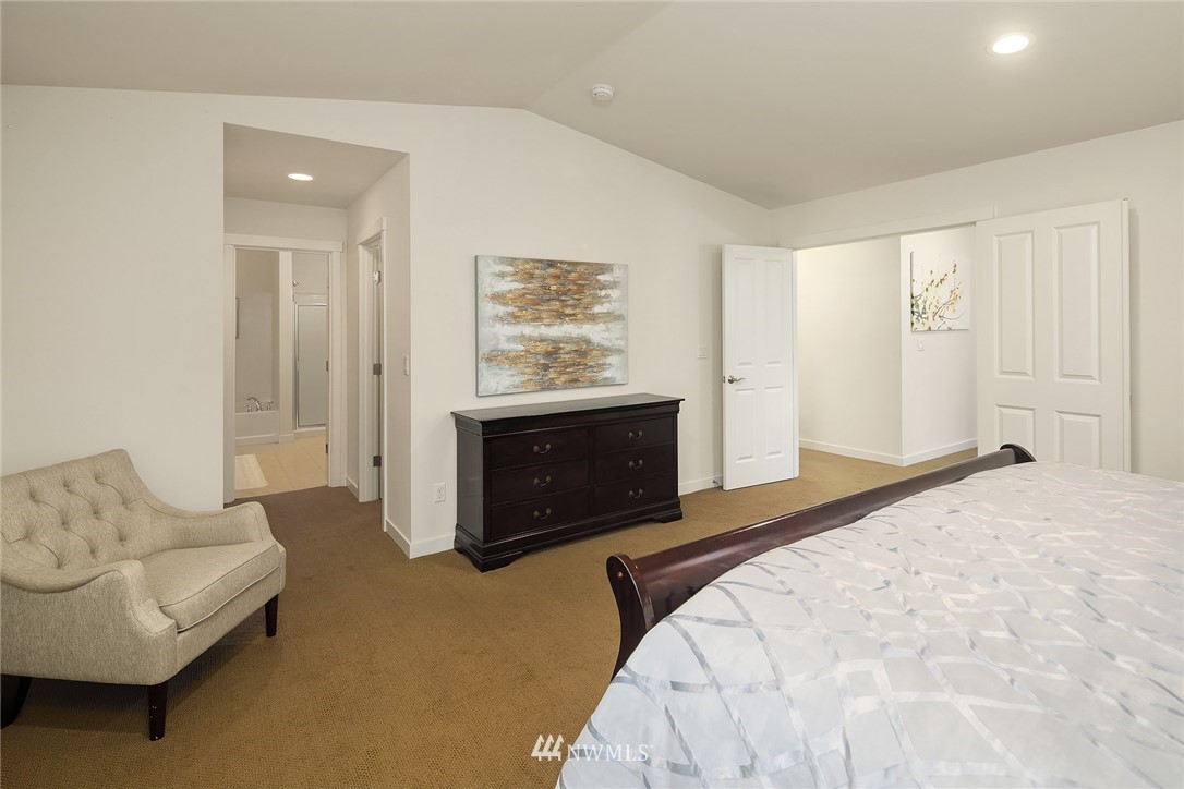 3728 224th Street Southeast Bothell, WA 98021 - Photo 8 of 22 a spacious bedroom with a bed and a couch