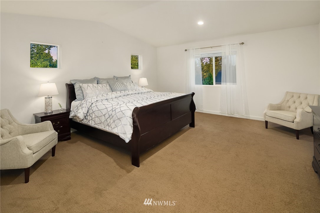 3728 224th Street Southeast Bothell, WA 98021 - Photo 9 of 22 a spacious bedroom with a bed and a couch