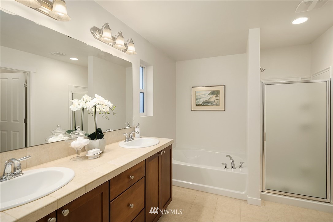 3728 224th Street Southeast Bothell, WA 98021 - Photo 10 of 22 a bathroom with a tub a sink and mirror