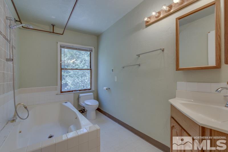 935 Vine Street Reno, NV 89503 - Photo 9 of 18 a bathroom with a bathtub and a sink