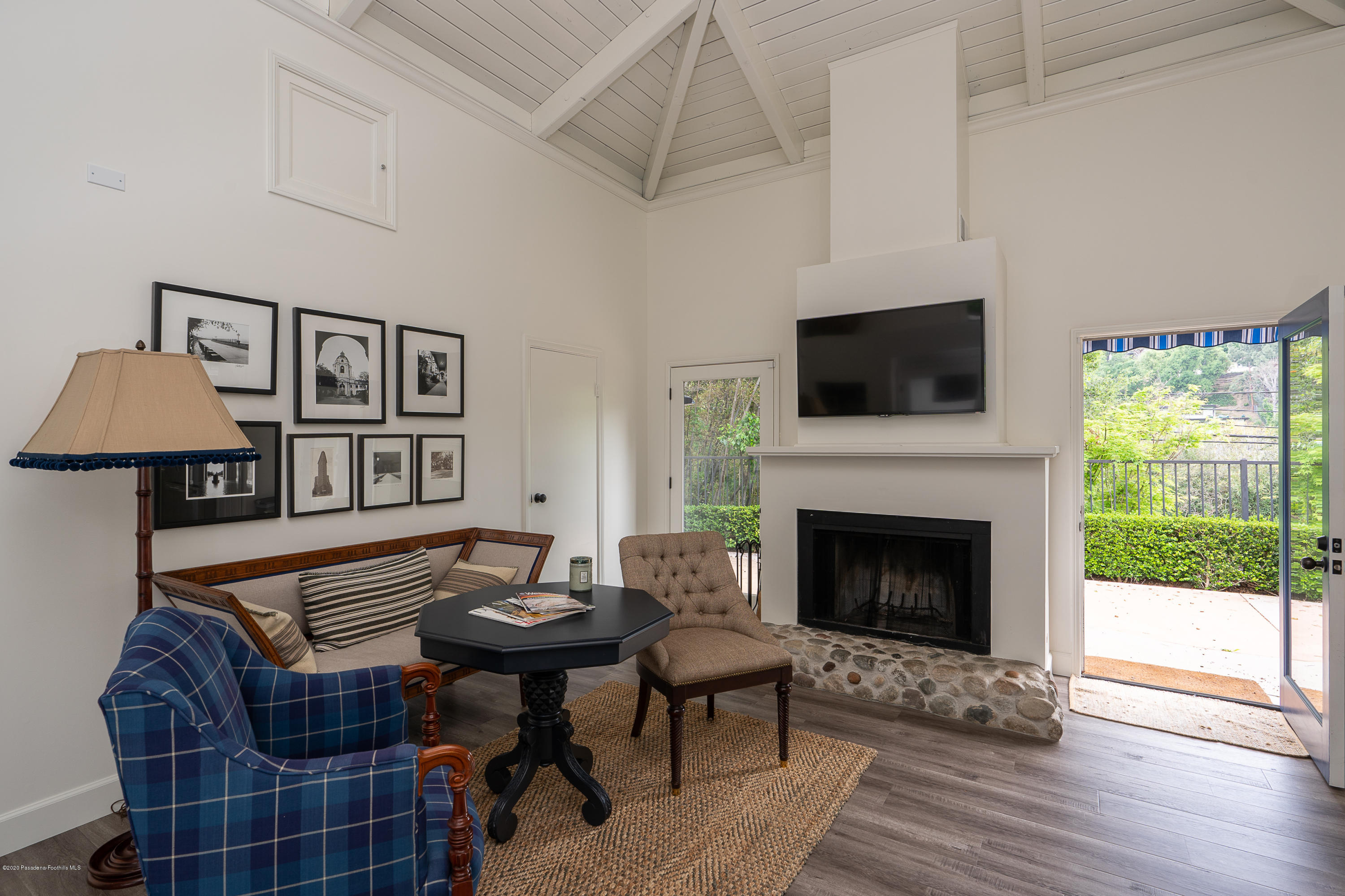 700 Laguna Road Pasadena, CA 91105 - Photo 22 of 31 a living room with furniture a flat screen tv and a fireplace