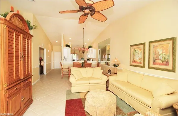 a living room with fireplace furniture and a chandelier