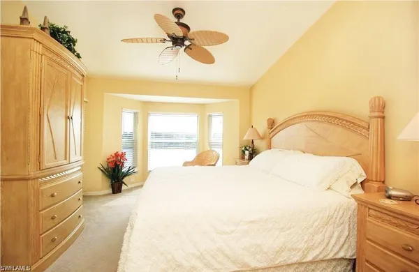 a bedroom with a bed dresser and a window