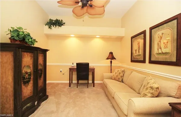 a living room with furniture flowerpot and a chandelier