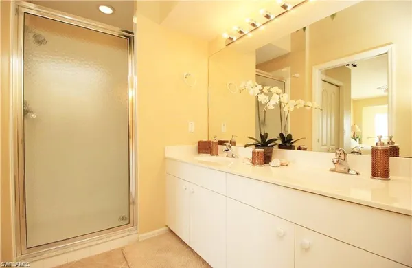 a bathroom with a double vanity sink mirror and