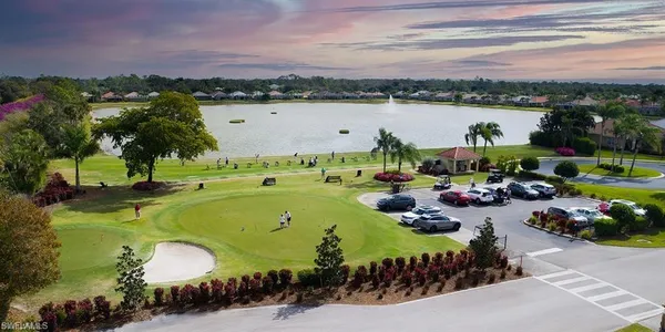 an aerial view of a house with outdoor space and lake view in back