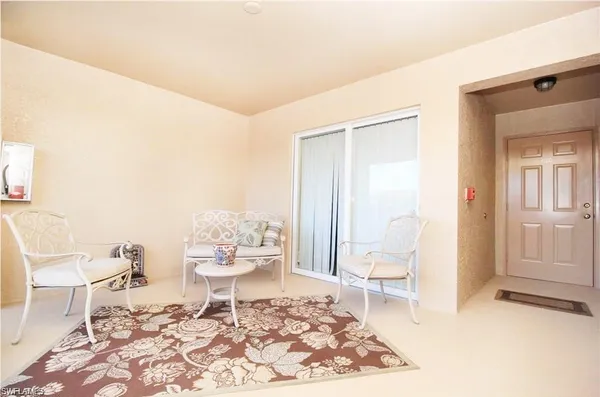 a living room with a rug and a dining table