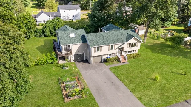 an aerial view of a house with a yard