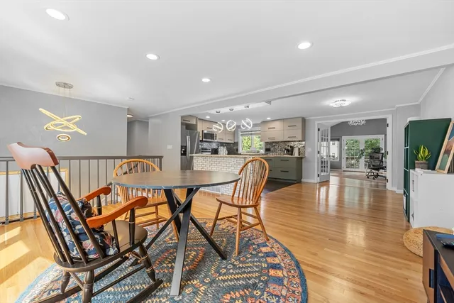 a dining room with furniture a rug and wooden floor