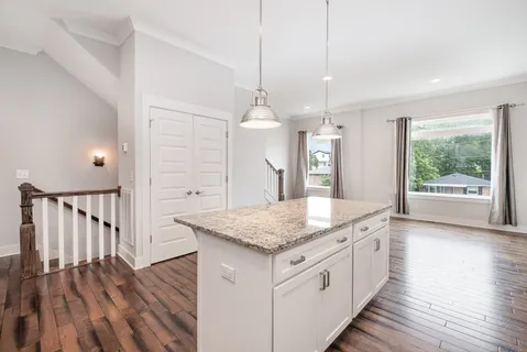 a kitchen with a counter top space and wooden floor