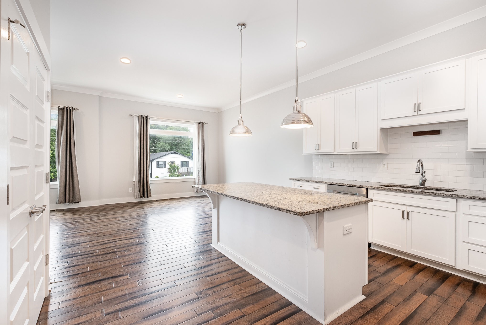 1106 Wade Avenue, Unit 5 Nashville, TN 37203 - Photo 12 of 33 a kitchen with granite countertop a stove a sink a center island and wooden floor