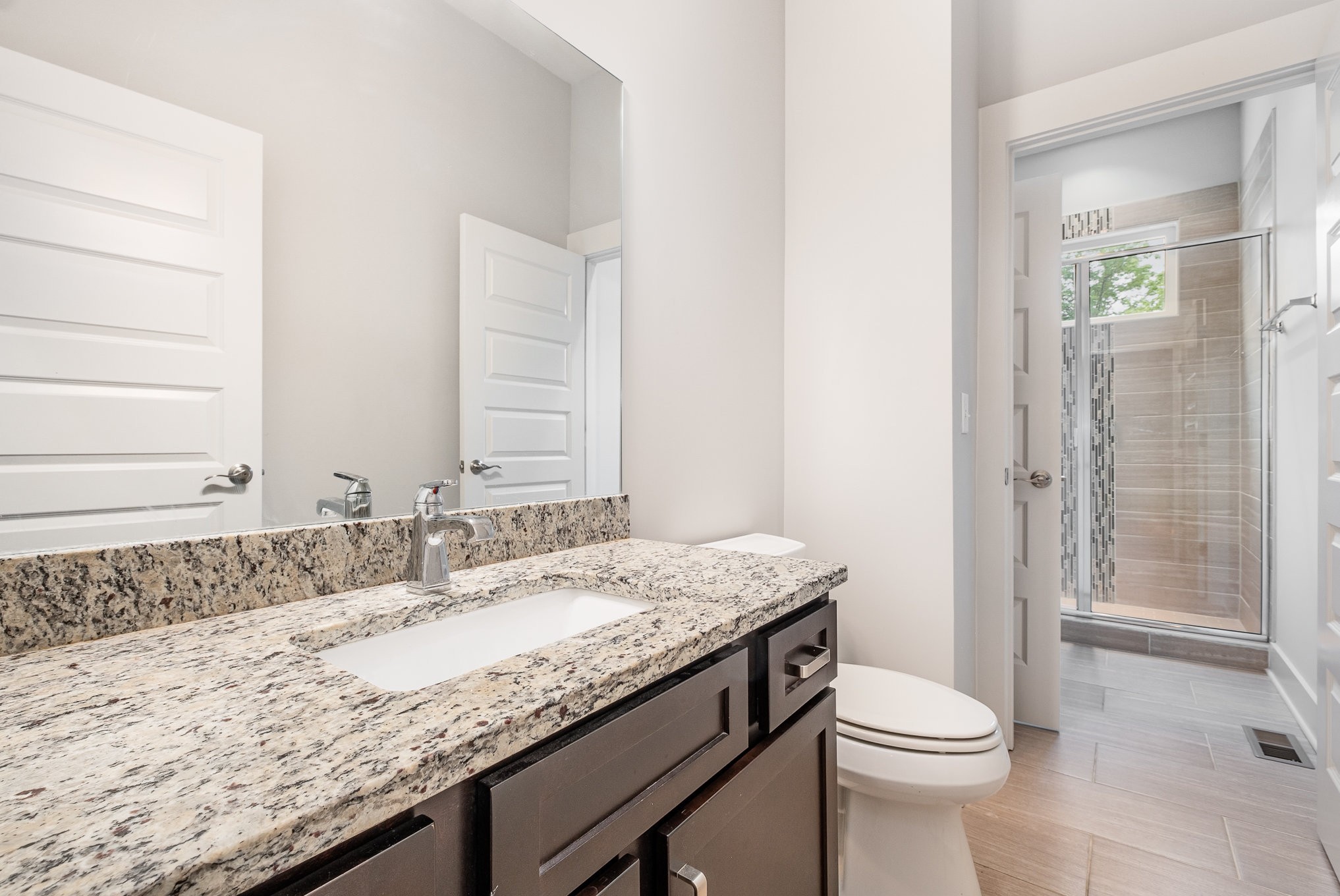 1106 Wade Avenue, Unit 5 Nashville, TN 37203 - Photo 17 of 33 a bathroom with a granite countertop sink a toilet and shower