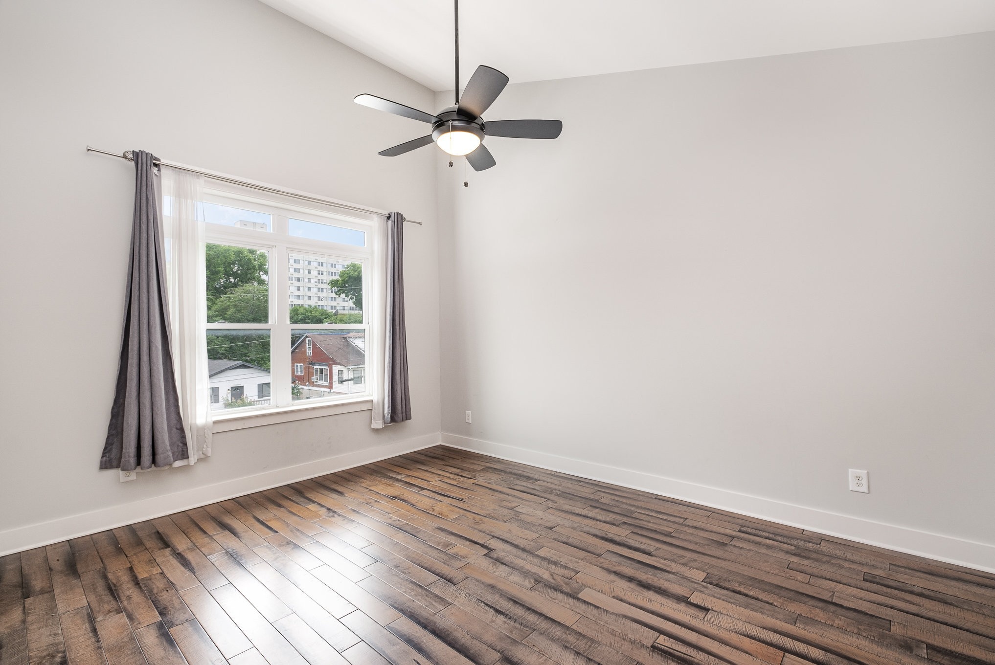 1106 Wade Avenue, Unit 5 Nashville, TN 37203 - Photo 19 of 33 an empty room with wooden floor fan and windows
