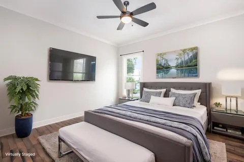 a bedroom with a bed and a potted plant