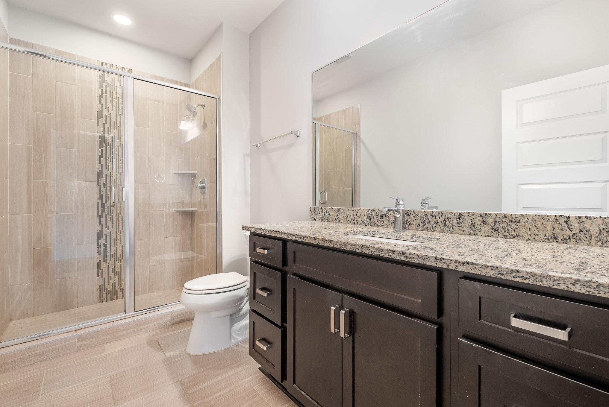 1106 Wade Avenue, Unit 5 Nashville, TN 37203 - Photo 22 of 33 a bathroom with a granite countertop sink toilet and shower