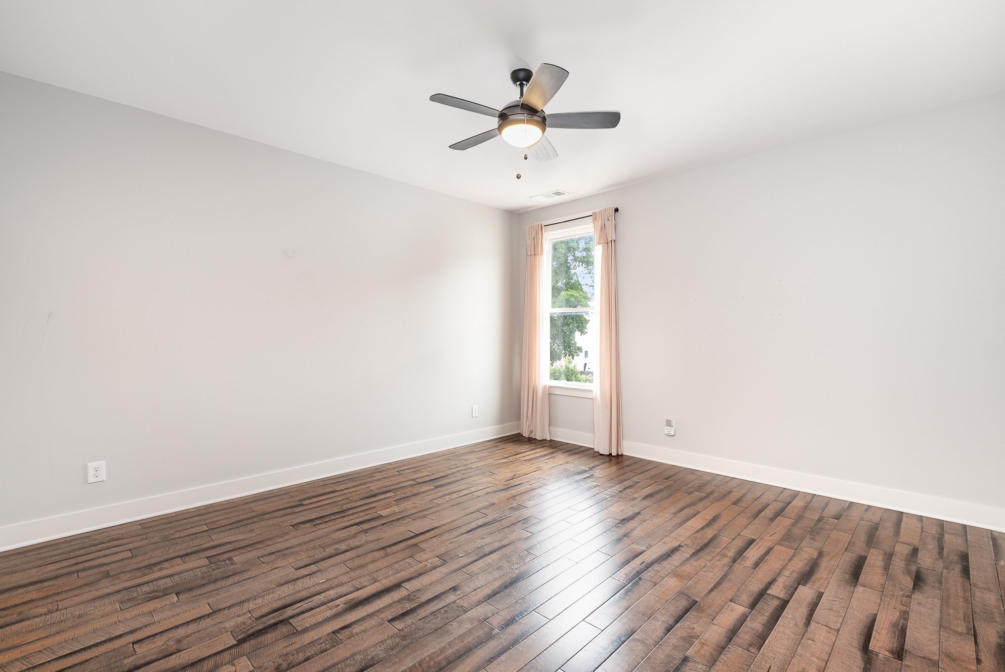 1106 Wade Avenue, Unit 5 Nashville, TN 37203 - Photo 23 of 33 an empty room with wooden floor chandelier fan and windows