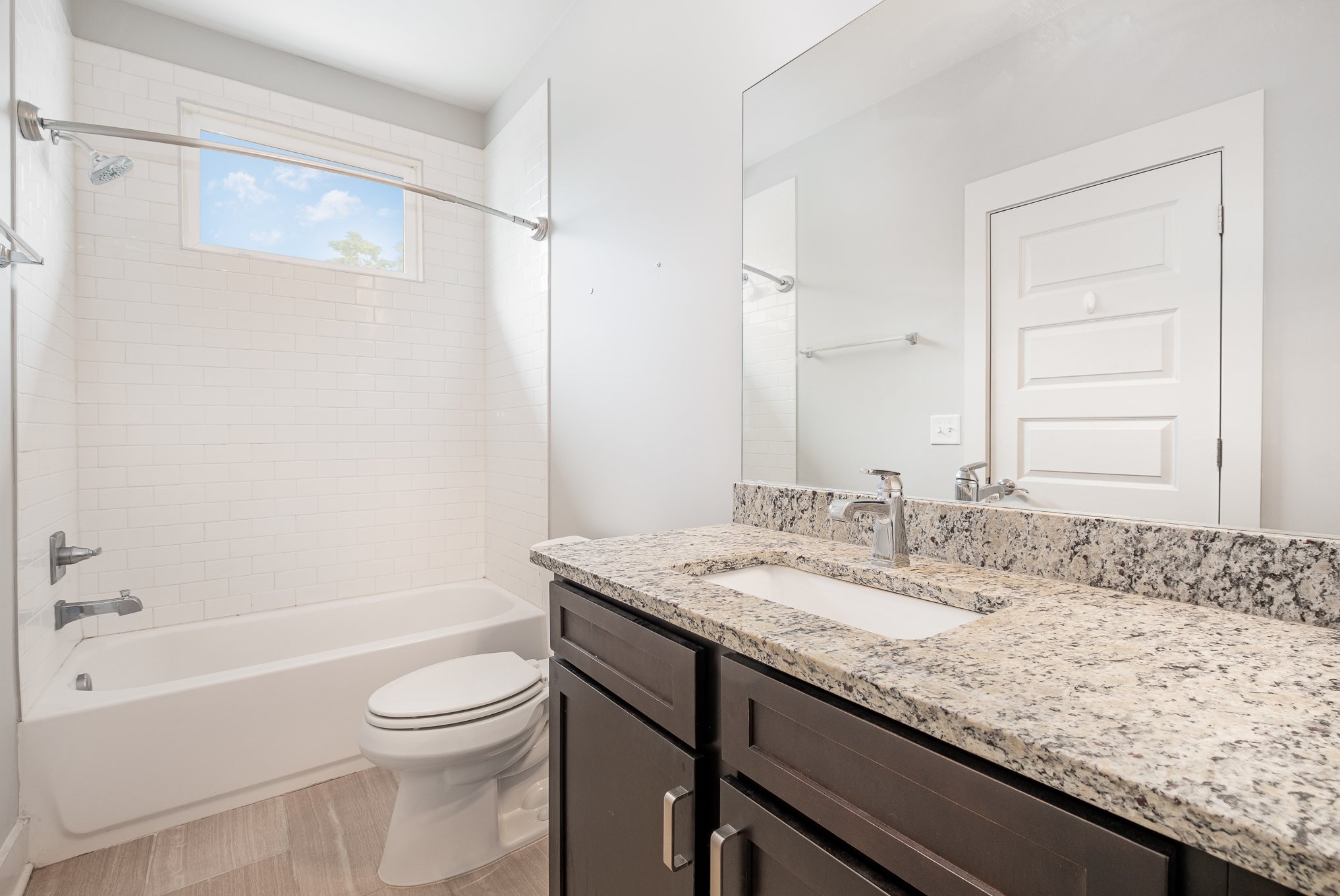 1106 Wade Avenue, Unit 5 Nashville, TN 37203 - Photo 24 of 33 a bathroom with a granite countertop sink a toilet and shower