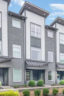 a front view of a residential apartment building with a yard