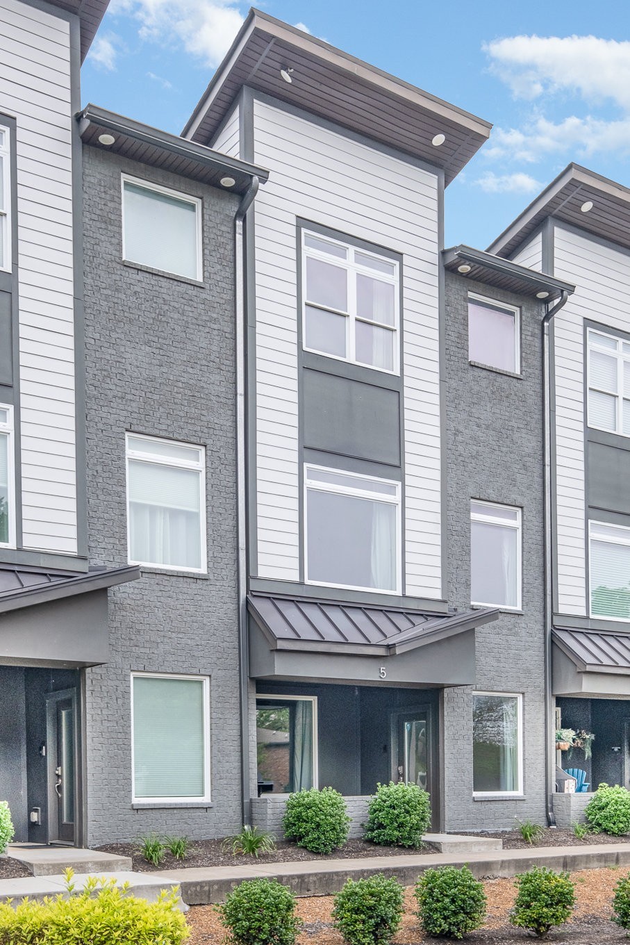 1106 Wade Avenue, Unit 5 Nashville, TN 37203 - Photo 26 of 33 a front view of a residential apartment building with a yard