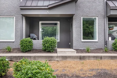 a view of front door and potted plants