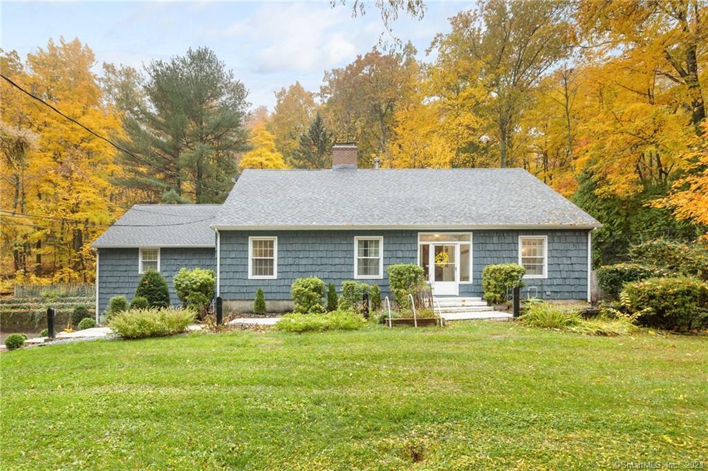 a front view of house with yard and green space