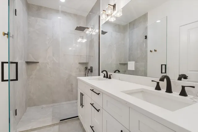 a bathroom with a sink double vanity and shower