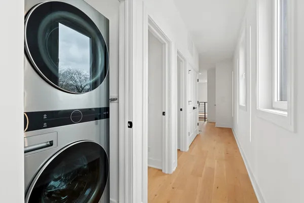 a view of a hallway with washer and dryer