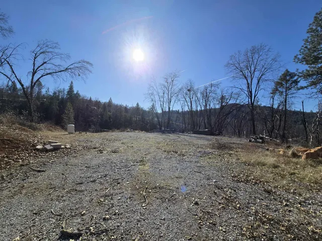 a view of backyard with wooden fence