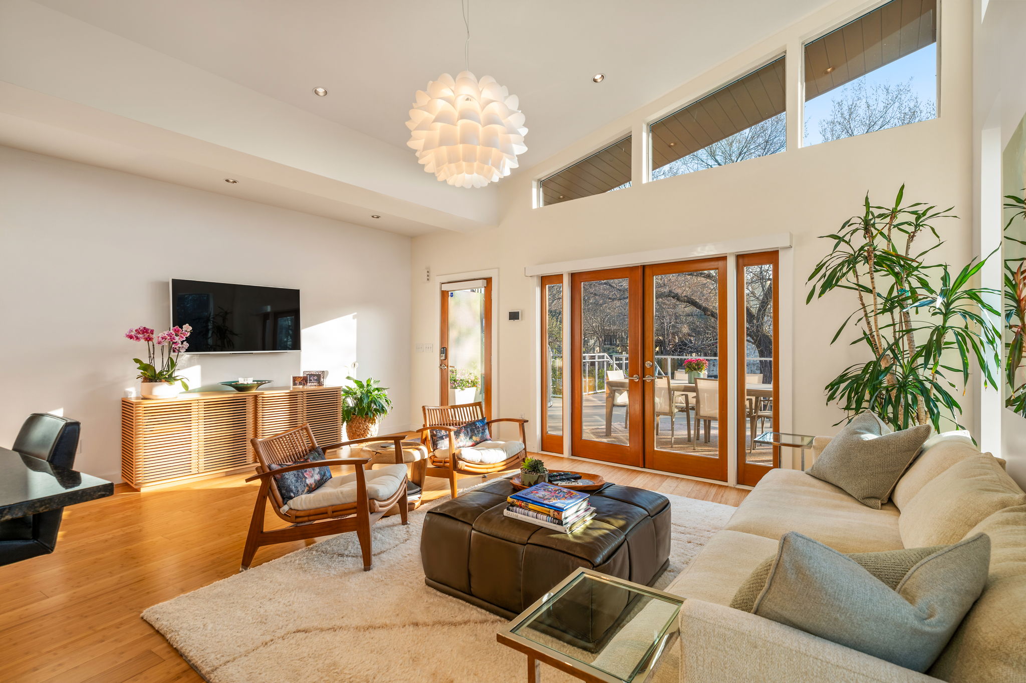 1700 Ravey Street, Unit A Austin, TX 78704 - Photo 10 of 40 Living area featuring french doors, light wood-style flooring, a high ceiling, and hanging lights
