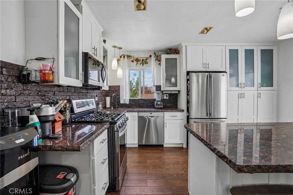 6412 Shawnee Road Westminster, CA 92683 - Photo 8 of 36 a kitchen with stainless steel appliances granite countertop a refrigerator a stove and a sink