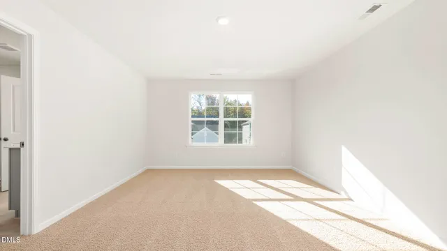 a view of a kitchen with wooden floor and a window