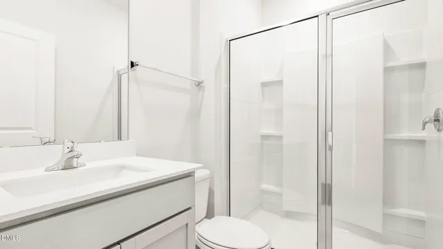 a kitchen with stainless steel appliances a refrigerator sink and white cabinets